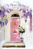 A softly lit doorway in Old Oak Common is dressed with flowers in a way that feels both tender and welcoming. The pink front door, painted in a muted pastel shade, stands at the centre of the scene, its smooth, matte surface catching a gentle wash of daylight that could be drifting in from a quiet residential street near Old Oak Common station. Overhead, wisteria cascades down in generous sprays, their lavender and lilac blossoms forming a natural arch that frames the door and adds a sense of romantic charm. The walls on either side are whitewashed, their pale colour echoing the lightness of the flowers and allowing the pastel tones to breathe. On the doorstep itself, a vintage-style grey metal bucket has been carefully positioned, brimming with white and cream roses that appear freshly arranged. The roses are plump and velvety, their petals unfurling in soft layers, accompanied by sprigs of delicate green foliage that add texture and a hint of movement. A soft pink ribbon is tied around the base of the bucket, its colour mirroring the door and drawing the whole scene together with a quiet, coordinated elegance. The mood is one of gentle celebration, the kind you might feel when you first step into a new flat or house in Old Oak Common and realise it is truly yours. This floral doorway feels ready to greet new owners, visiting family, or friends bringing their congratulations, radiating a calm optimism and the comforting promise that every arrival here will be met with warmth, beauty, and a sense of belonging.